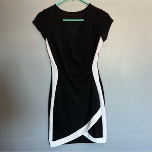 Black and white fitted dress. No tag but fits like a medium. Very flattering